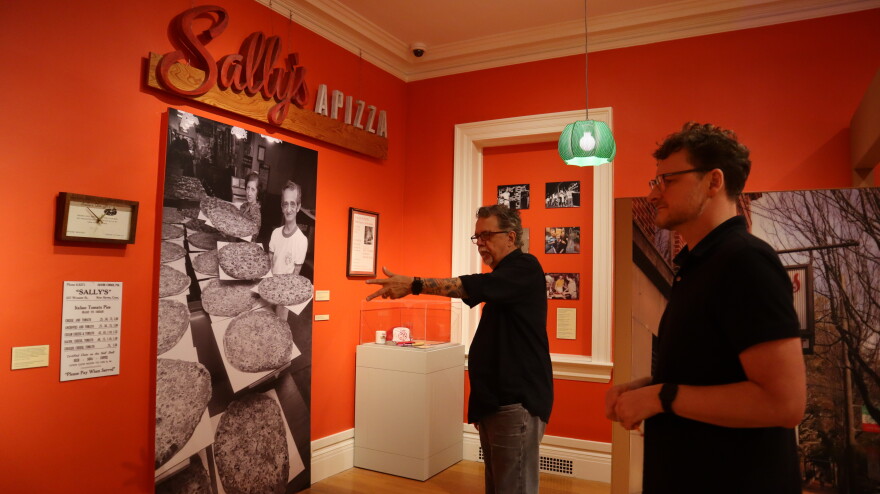 Filmmaker Gorman Bechard (left) discusses the Sally’s Apizza exhibit with New Haven Museum curator Jason Bischoff-Wurstle (right).