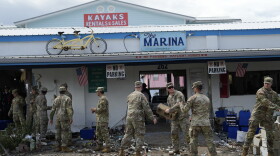 Members of the National Guard assist storm-damaged business The Marina with moving and piling debris in Horseshoe Beach, Fla., Thursday, Aug. 31, 2023, one day after the passage of Hurricane Idalia.
