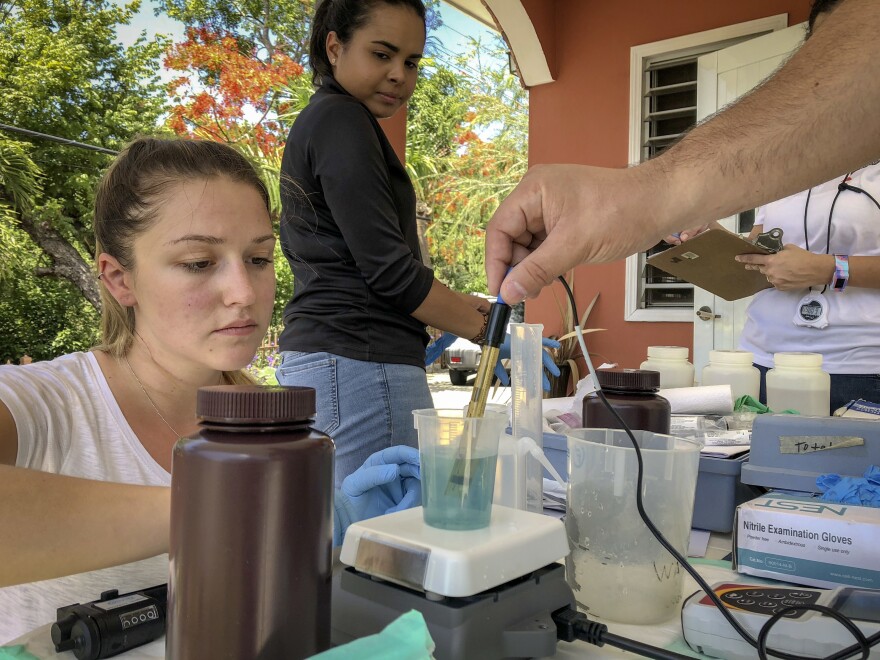 Graduate student Melanie Warren and laboratory technician Taina Rodriguez Curet work with Fernando Rosario-Ortiz to test tap water samples in Puerto Rico for lead. Initial results suggest potentially dangerous levels of lead in some drinking water that Rosario-Ortiz hopes to investigate further in larger studies.