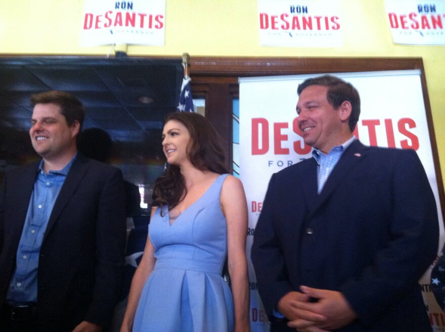 Rep. Matt Gaetz, left, with Ron DeSantis and his wife