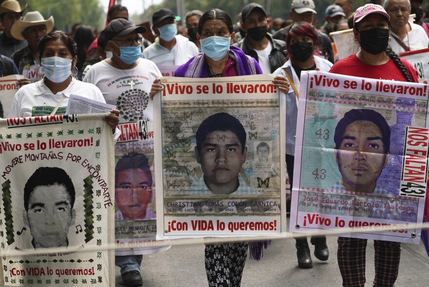 Family members and friends march seeking justice for the missing 43 Ayotzinapa students in Mexico City on Friday.