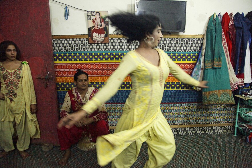 Transgender women dance for visitors in an apartment where they live together in Lahore.