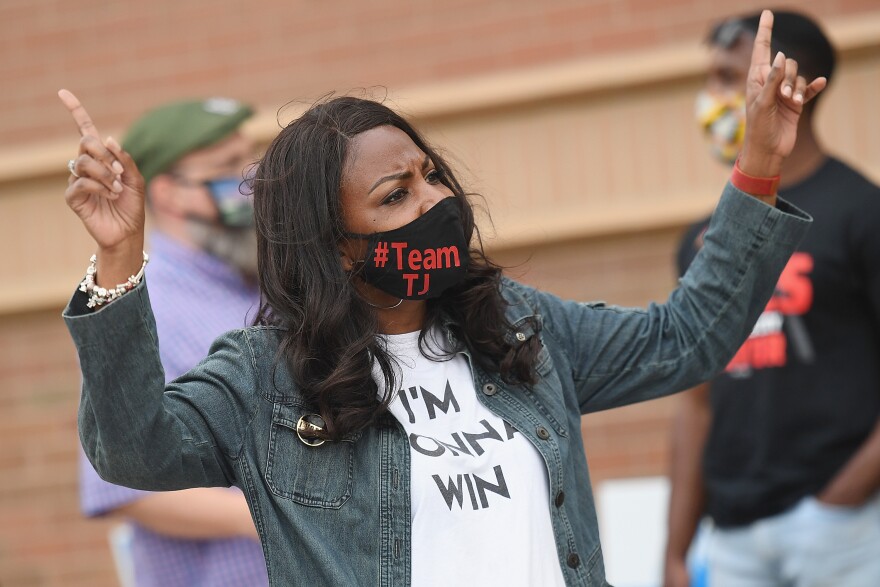 St. Louis mayoral candidate Tishaura Jones dances with supporters during a campaign stop outside Lexington Elementary School on April 6, 2021.