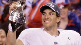New York Giants quarterback Eli Manning holds the Vince Lombardi Trophy after the NFL Super Bowl XLVI game against the New England Patriots, Sunday (Feb. 5, 2012).