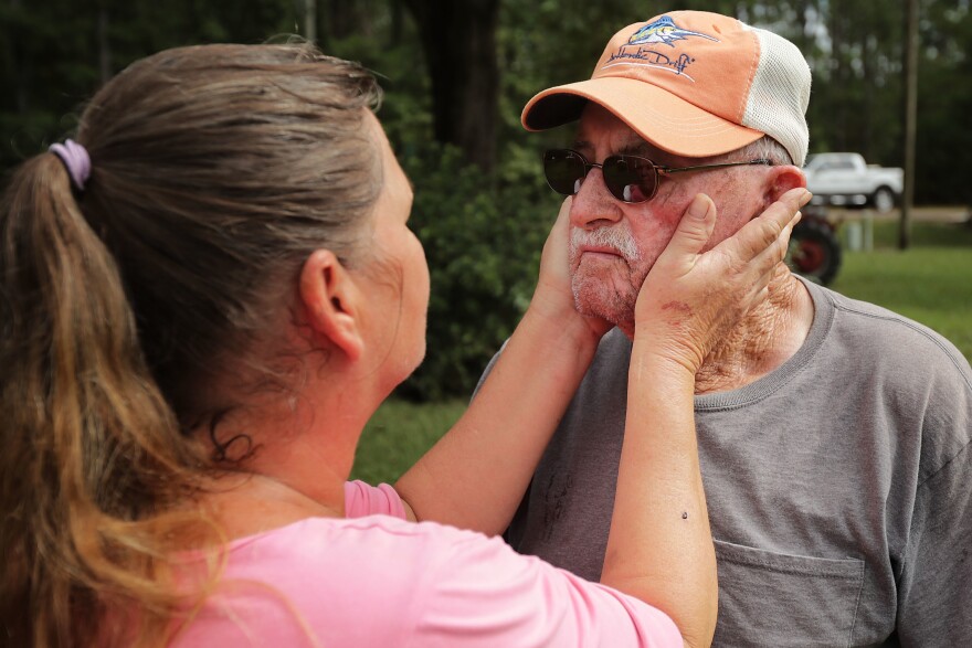 George Skinner, 83, is comforted by his neighbor Mary Ann Dunn after their homes were damaged by floodwaters from the Nuese River in Kinston, N.C., on Monday. Since the creek behind his home first overflowed during Hurricane Floyd in 1999, Skinner said each subsequent storm has produced worse flooding. After Hurricane Florence, his whole family is leaving and does not plan on returning.