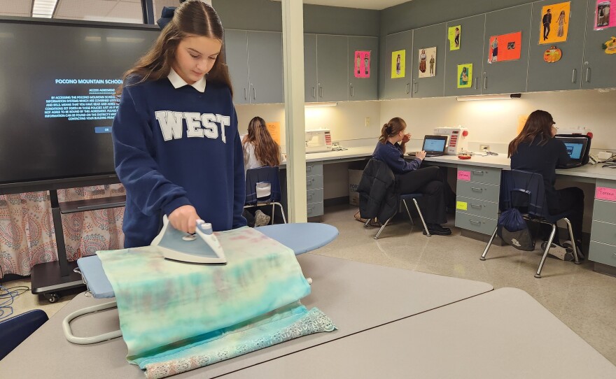Freshman Angelina Sauerwein works on a dress that will be sent to Africa.