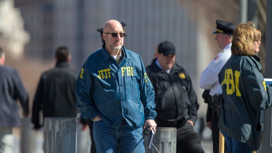 Authorities gather near the White House, which was placed on lockdown Saturday, after a man fired a gun near the fence, according to the Secret Service.