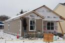 External image of a man finishing work on a new house. The house is on McCleary Avenue in Dayton, Ohio.
