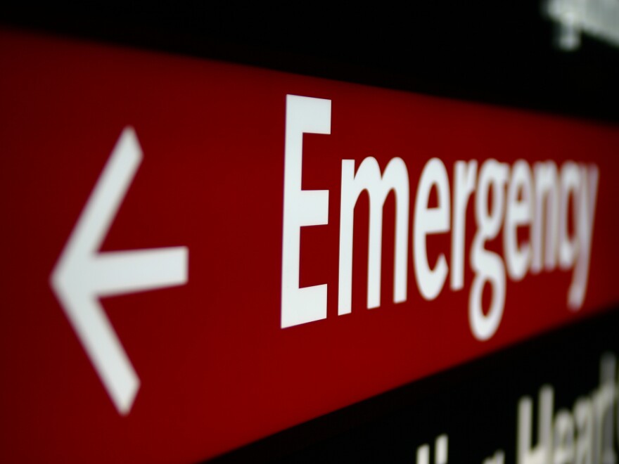 A red sign with "emergency" written on it and an arrow points to the left.