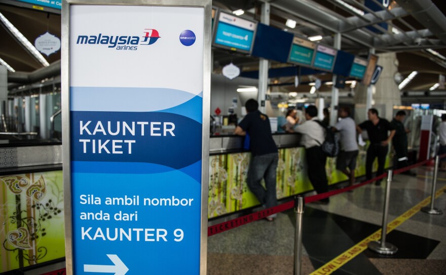 Passengers queue up at Malaysia Airlines ticket counters at Kuala Lumpur International Airport in Sepang on July 21.
