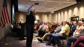 Former Governor Jay Inslee records a video for Rep. Dan Newhouse with attendees of The People’s Town Hall Wednesday, April 9, 2025, at Yakima Convention Center in Yakima, Wash. (Credit: Evan Abell / Yakima Herald)