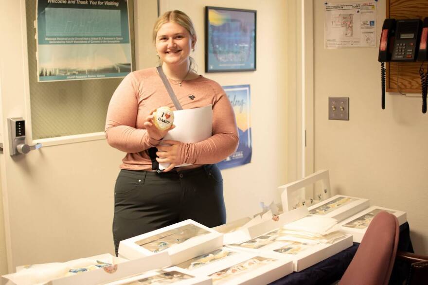 UAF chemistry student Aggy Boldt grabbed a bespoke frosted sugar cookie at the facility’s entrance on June 14, 2025. She said she was most excited about visiting the array.
