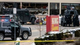Smashed windows are left at the scene after a gunman opened fire at a King Sooper's grocery store in Boulder, Colorado. Ten people, including a police officer, were killed in the attack.   
