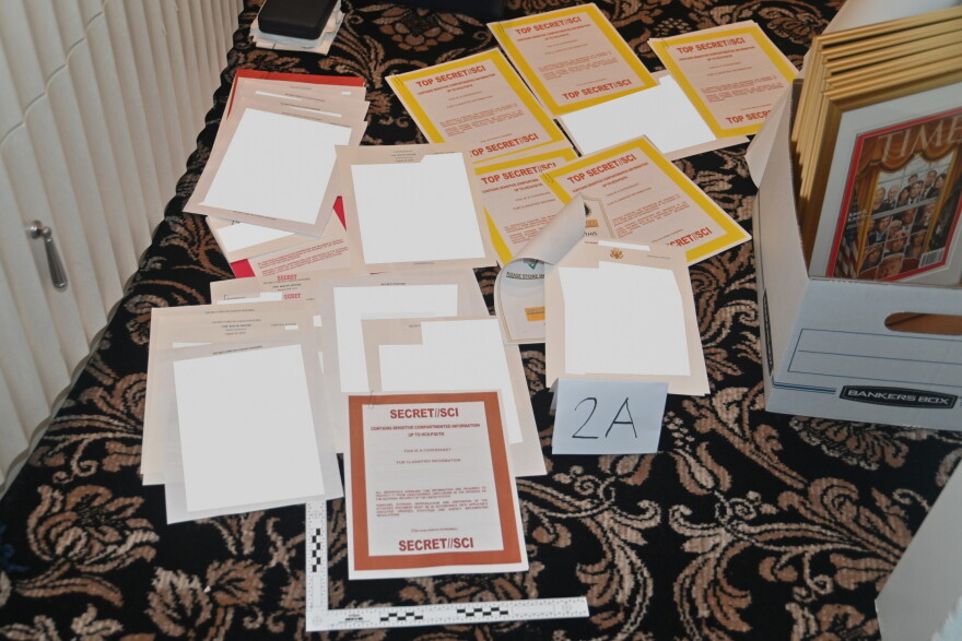 This image contained in a court filing by the Department of Justice on Aug. 30, 2022, and partially redacted by the source, shows a photo of documents seized during the Aug. 8 FBI search of former President Donald Trump's Mar-a-Lago estate. 