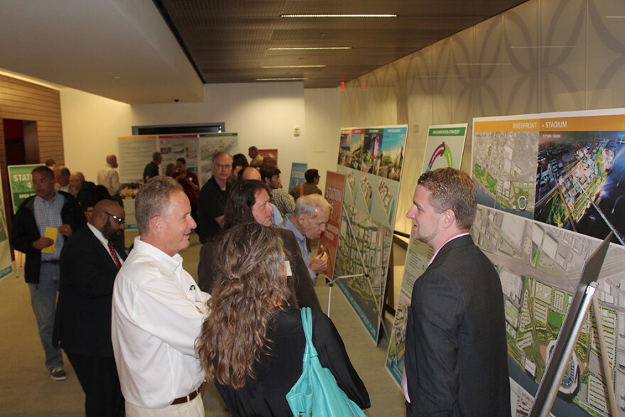 People interested in Great Rivers Greenway's plans to revitalize the north riverfront look at renderings and speak to representatives of Forum Studios Wednesday July 8, 2015. Forum was hired to develop the plan.