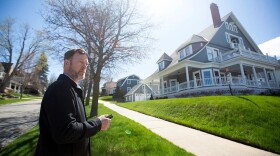 David Shuman, principal broker at Bay North Realty, talks about a large home for sale on Bay Street in Petoskey. The six bedroom and 3.5 bathroom home is listed for nearly $2 million. (Photo: Kathy Kieliszewski/Bridge Michigan)