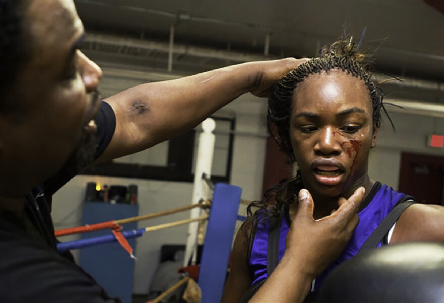 Jason Crutchfield, Claressa's coach, examines her after a sparring session at Berston Field House in Flint, Michigan. Claressa trained at Berston from age 11 to 17. When she was 13, and before it was announced that women would be allowed to box in the Olympics, Crutchfield predicted she would win the Olympic gold.