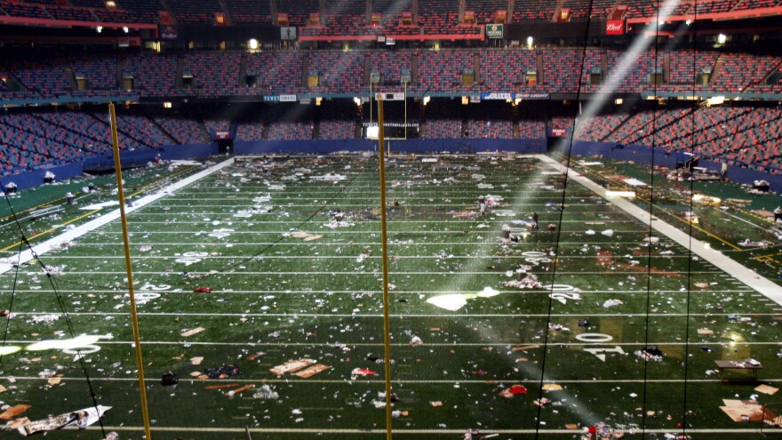 Huge shafts of light strike the littered playing field of the Louisiana Superdome in New Orleans on Sept. 2, 2005, four days after Hurricane Katrina. The Superdome was a squalid shelter to tens of thousands of residents for days after the storm, including the Halley sisters and their mother.