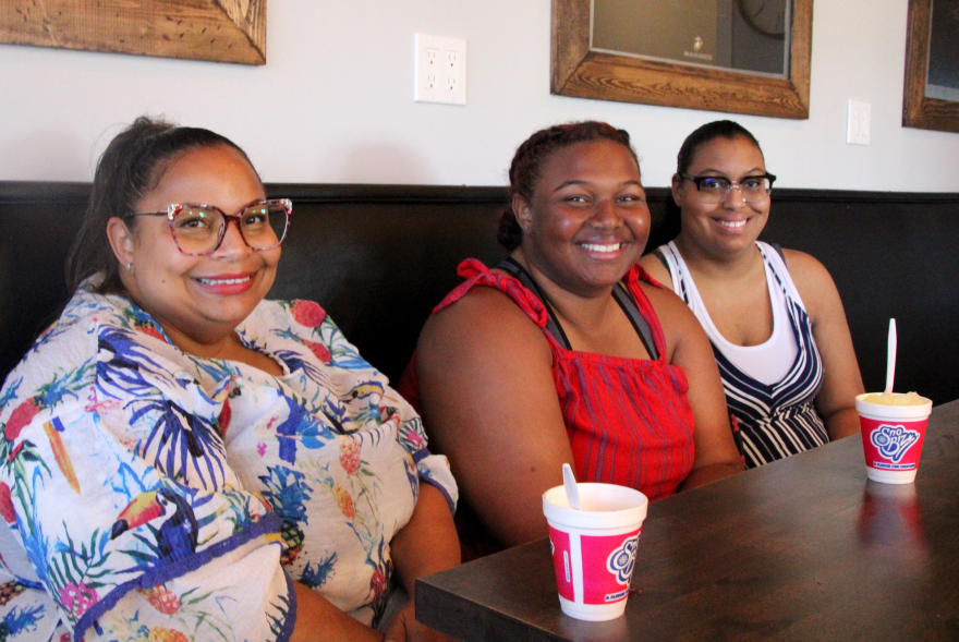 Shereka Barnes and her two daughters, Avyon and Aireanna, stop by Fitti's Espresso for a treat during a break from packing for school.