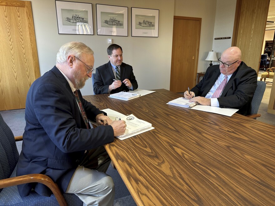 Cole County Circuit Judge Jon Beetem, from left, Missouri Secretary of State Jay Ashcroft and Cole County Circuit Judge Daniel Green review and sign the official results of the November election while meeting as the Board of State Canvassers, at Ashcroft's office in Jefferson City, Missouri, Thursday, Dec. 5, 2024.