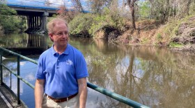 Man standing next to a river