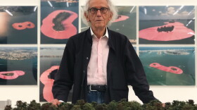 Bulgarian artist Christo stands in front of the exhibition honoring his artistic project "Surrounded Islands" at the Perez Art Museum.