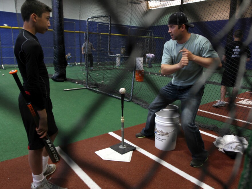 Reid Gorecki coaches a young player in a batting cage. Remembering the first hit he got in the majors, Gorecki calls it "a dream come true."