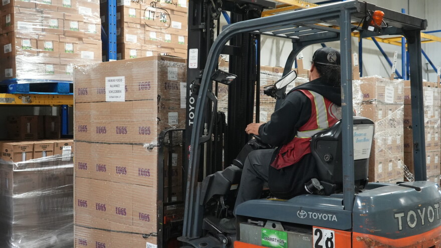 A Hawaiʻi Foodbank worker unloads the first batch of eggs that arrived in Honolulu on Sep. 14.