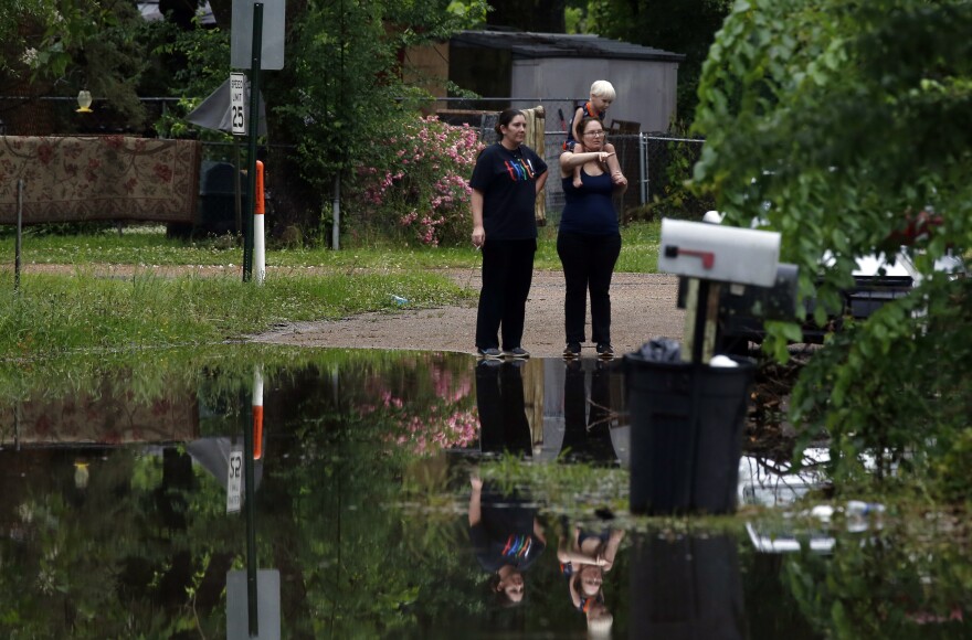 Residents in Pearl, Miss., watch the morning flash flood waters on Thursday.