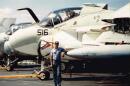 Former Navy sailor Louis Miller stands on the deck of the USS Enterprise aircraft carrier. Miller was kicked out of the Navy in 1992 for being gay.