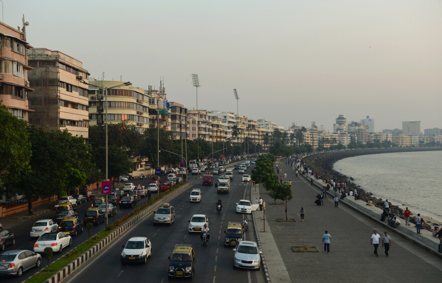 The Marine Drive seafront in Mumbai is lined with brightly colored buildings boasting curved corners, stylish balconies and decorative motif.