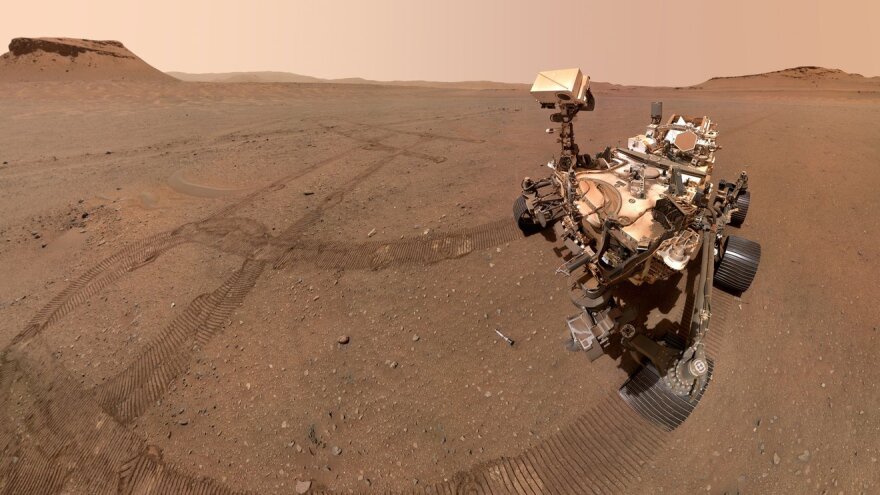 NASA's Perseverance rover takes a selflie looking down at one of its sample tubes. 