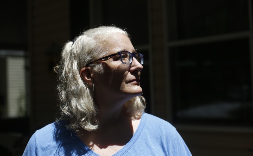 Melissa Preen stands beside boxes filled with her belongings as she prepares to move back to Cleveland, Ohio. She says she can no longer afford to live in Country Villa Estates in Riverview, Florida, due to rising lot rent and other fees.