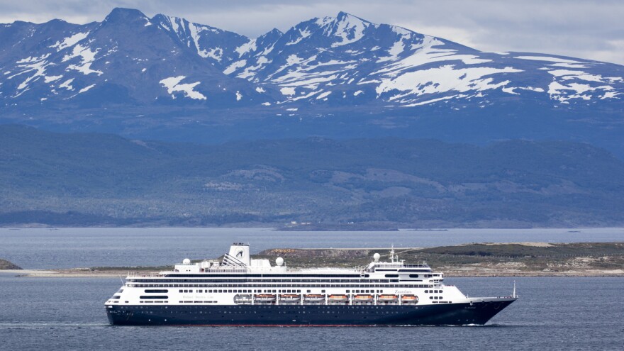 The Holland America cruise ship Zaandam sails past snow-capped mountains in Patagonia, Argentina.