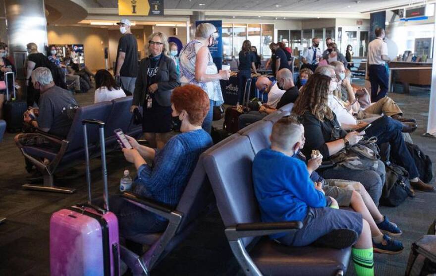 People wait in the concourse on June 17 at the Boise Airport, which had inaugural flights for service to Austin, Texas, and Chicago O’Hare International Airport.