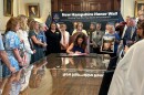 Governor Kelly Ayotte is surrounded by Stephanie Ouellette (left) and Charlene Marois (right) along other gold star advocates as she signs a bill providing Gold Star families special license plates.