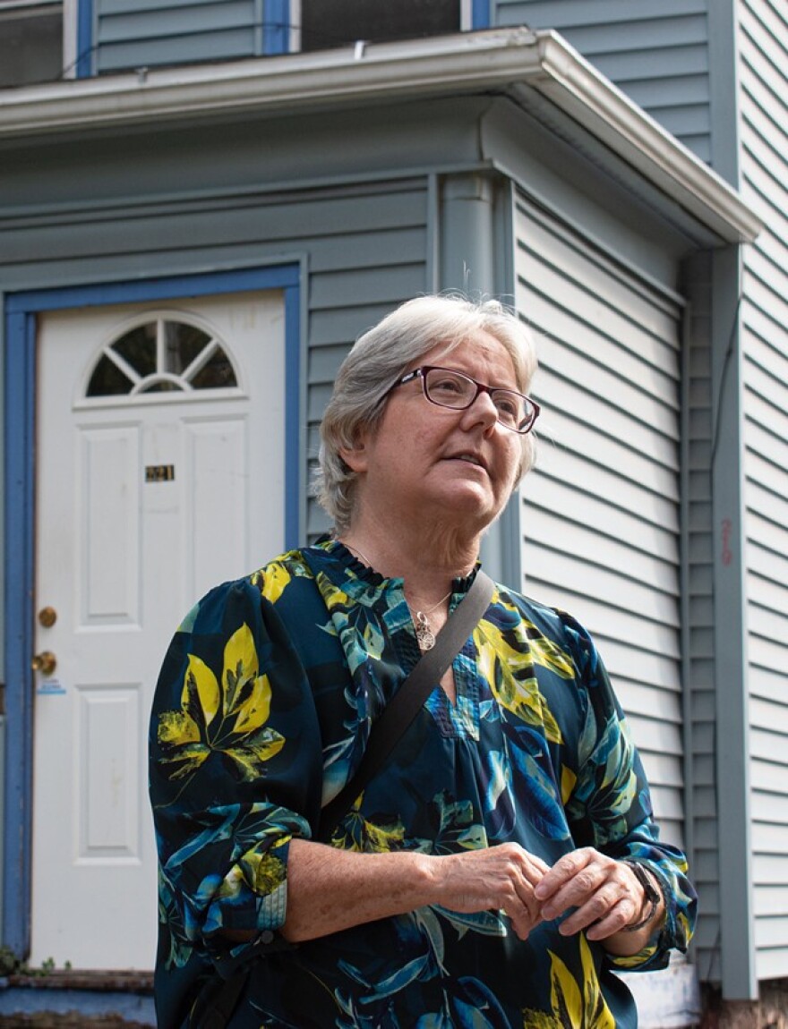 Nancy Johns Price, outside Malik Evans' childhood home/Lawrance Lee Evans' church.