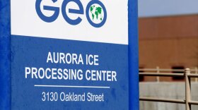  A blue sign that says "Aurora ICE Processing Center"