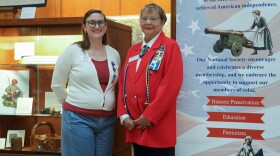 Brianna O'Shea, who leads the local Daughters of the American Revolution "E Pluribus Unum Educational Initiative," left, and Phyllis Breen, regent of the Irondequoit Chapter of the Daughters of the American Revolution, stand beside an exhibit exploring Rochester's connections to the American Revolution and its legacy. The exhibit features original artifacts from the New York State Museum and local collections and is presented by the Office of Rochester & Monroe County History, the Irondequoit Chapter of the Daughters of the American Revolution, and the Sons of the American Revolution.