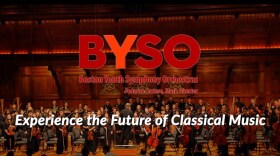 wood paneled concert hall with full orchestra standing, copy: Experience the Future of Classical Music