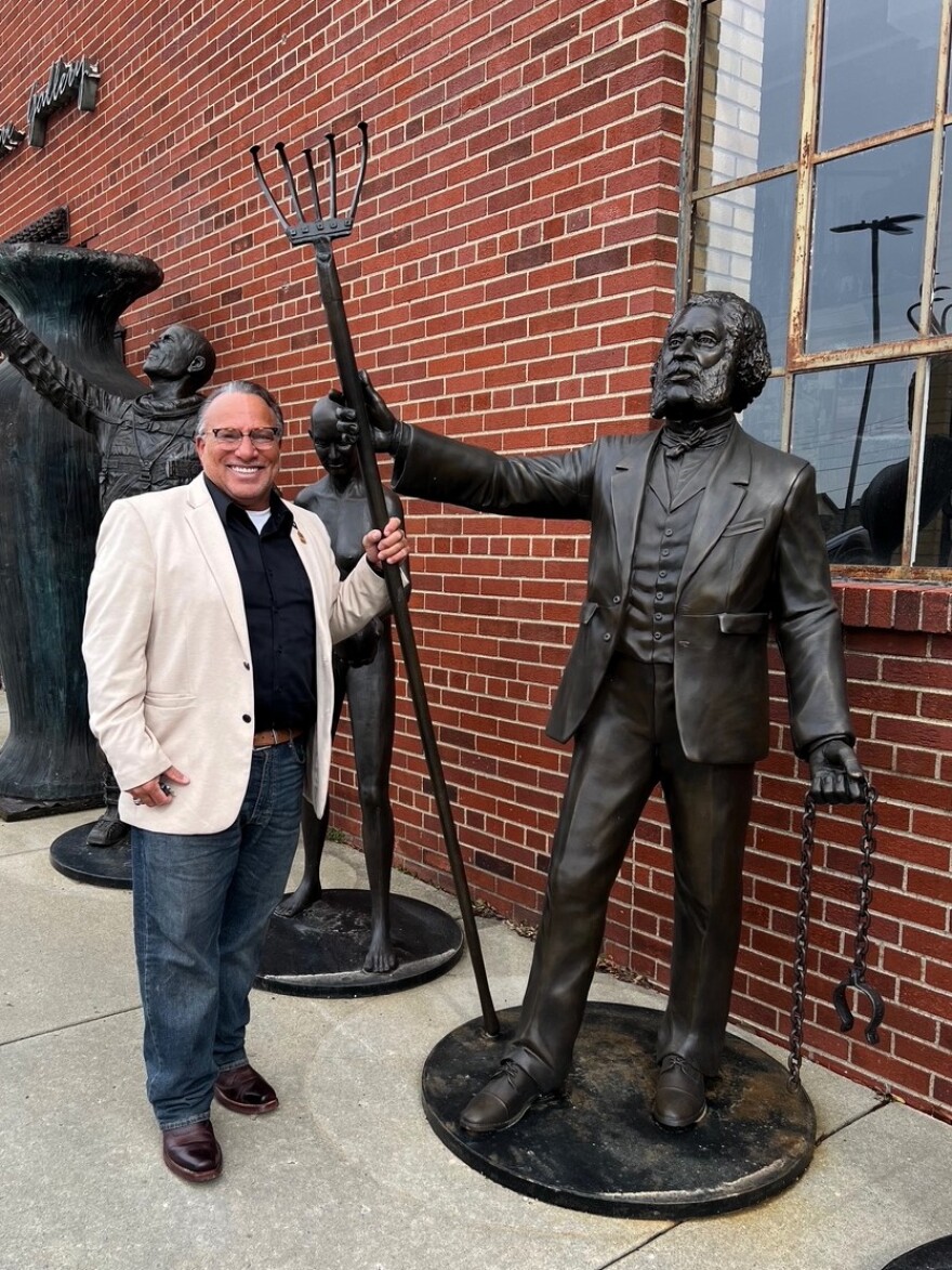 Todd Ware stands beside a life-sized statue of Nelson T. Gant.