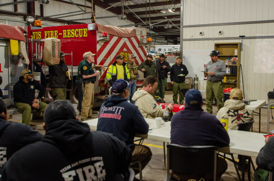 Firefighters gather for a briefing on the Solar Park Fire Tuesday morning.
