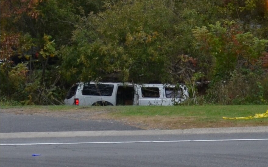 Crash-involved 2001 Ford Excursion stretch limousine at final rest in the ravine.