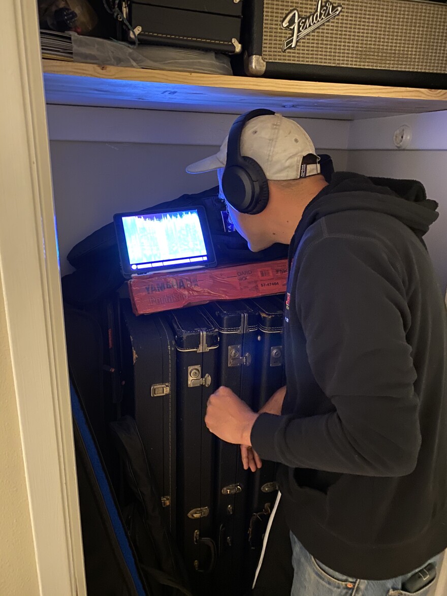 Nelson In Closet Taking Measurements.jpeg