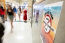 Students walk past a sign that reads Smart Kids Not Smart Devices.