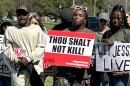 Bridget "Nicki" Scott (right) holds a sign with supporters at a rally in Baton Rouge, Louisiana, opposing the planned execution of her cousin, Jessie Hoffman Jr., on Sunday, March 16, 2025.