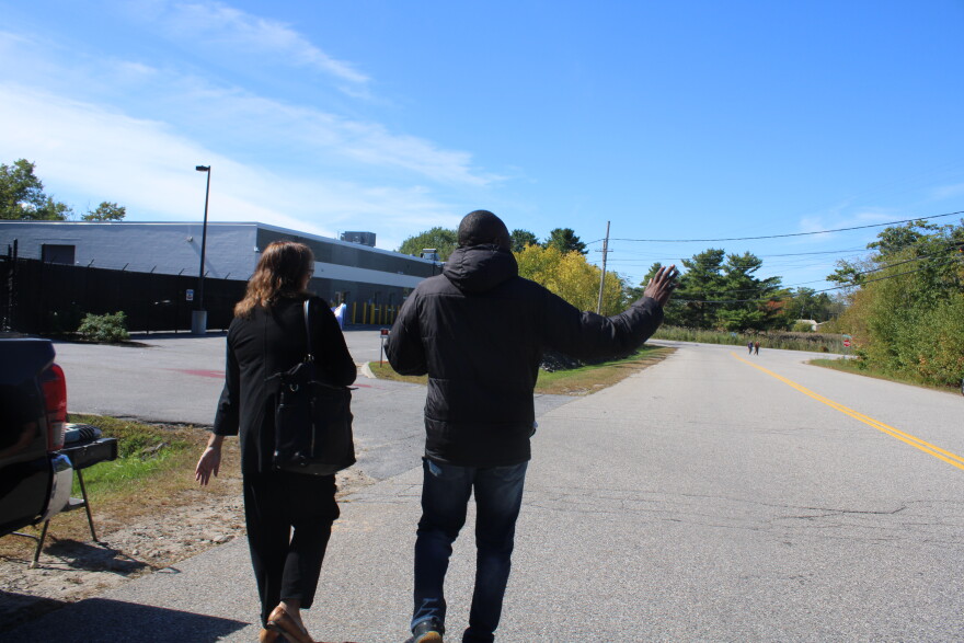 Dannick Massamba-Bankela waves at supporters as he walks into ICE's Scarborough field office with his lawyer on Tuesday, Sept. 22, 2026.