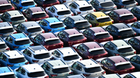 Rows of new cars packed tightly together with no space to move any of them.