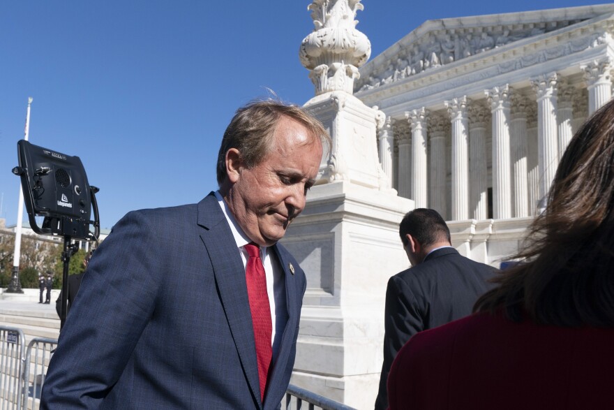 Texas Attorney General Ken Paxton, center, leaves after addressing anti-abortion activists at a rally outside the Supreme Court, Monday, Nov. 1, 2021, in Washington.