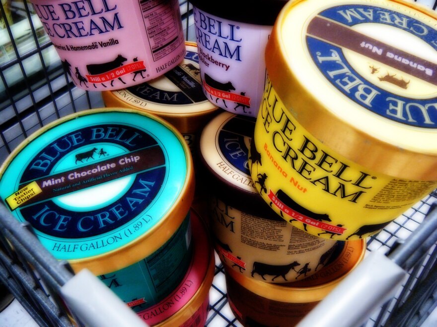 Several cartons of Blue Bell Ice Cream in a shopping cart